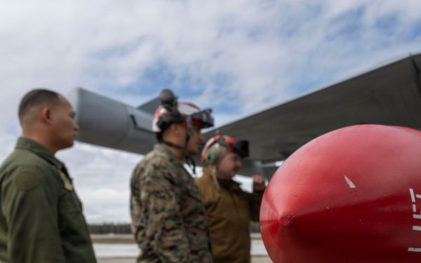 U.S. service members unload ordnance from aircraft participating in exercise Red Flag-Alaska