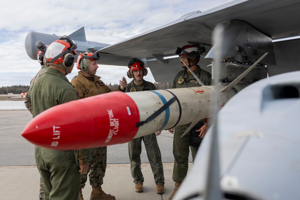 U.S. service members unload ordnance from aircraft participating in exercise Red Flag-Alaska