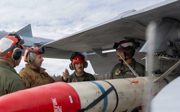 U.S. service members unload ordnance from aircraft participating in exercise Red Flag-Alaska