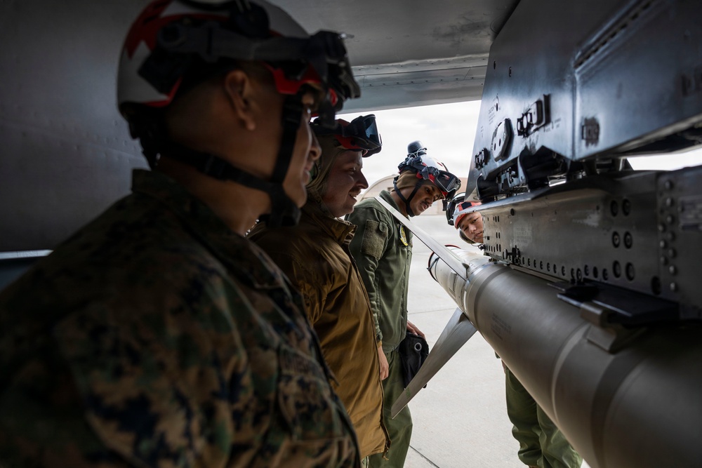 U.S. service members unload ordnance from aircraft participating in exercise Red Flag-Alaska