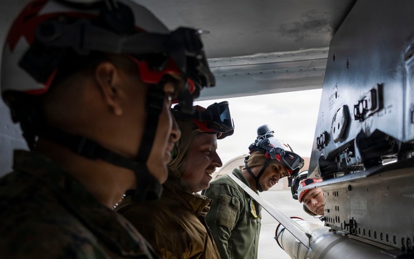 U.S. service members unload ordnance from aircraft participating in exercise Red Flag-Alaska