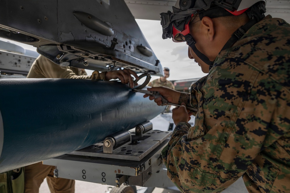 U.S. service members unload ordnance from aircraft participating in exercise Red Flag-Alaska