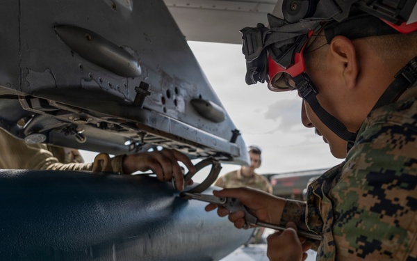 U.S. service members unload ordnance from aircraft participating in exercise Red Flag-Alaska