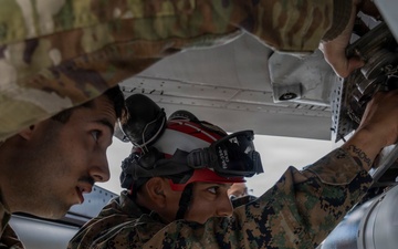 U.S. service members unload ordnance from aircraft participating in exercise Red Flag-Alaska