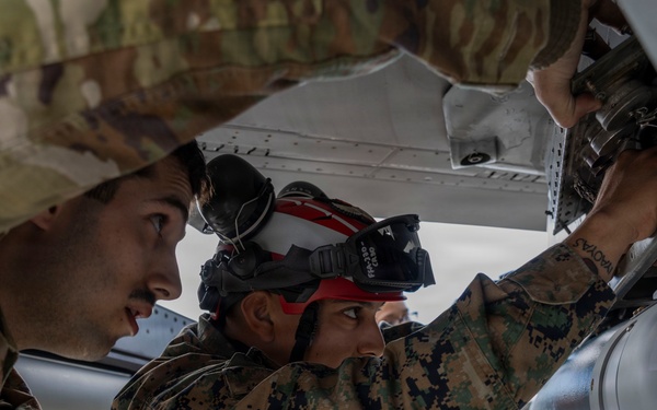 U.S. service members unload ordnance from aircraft participating in exercise Red Flag-Alaska