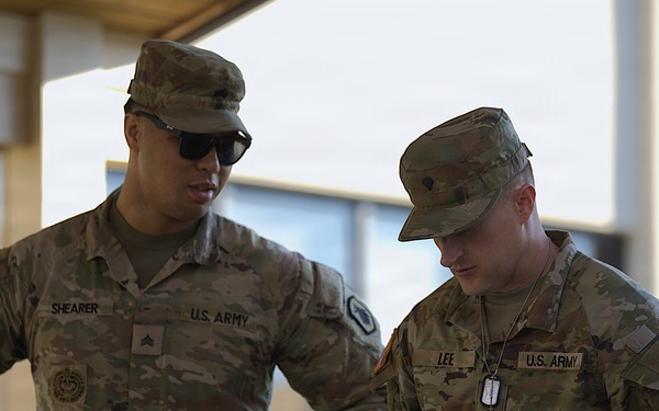 U.S. Army soldiers Shearer and Lee confer during military operations
