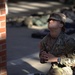 U.S. Army soldier pauses in quiet reflection near a brick structure during The Layout
