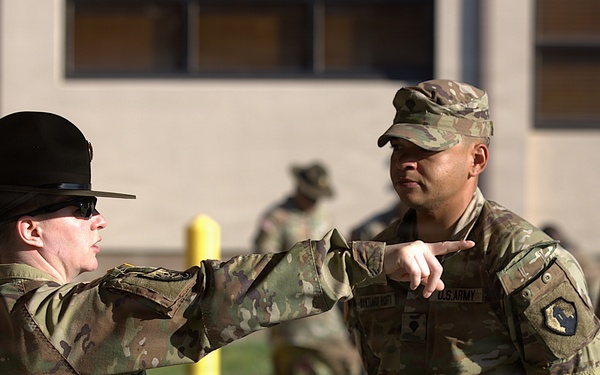U.S. Army drill sergeant instructs soldier during The Combined Best Squad Layout