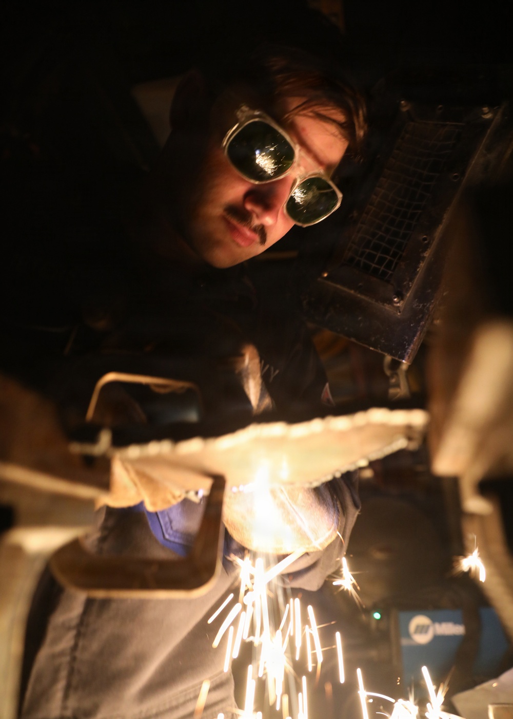USS Mitscher (DDG 57) Sailor fabricates metal in ship machine shop
