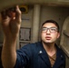 USS Mitscher (DDG 57) Sailor conducts hatch maintenance