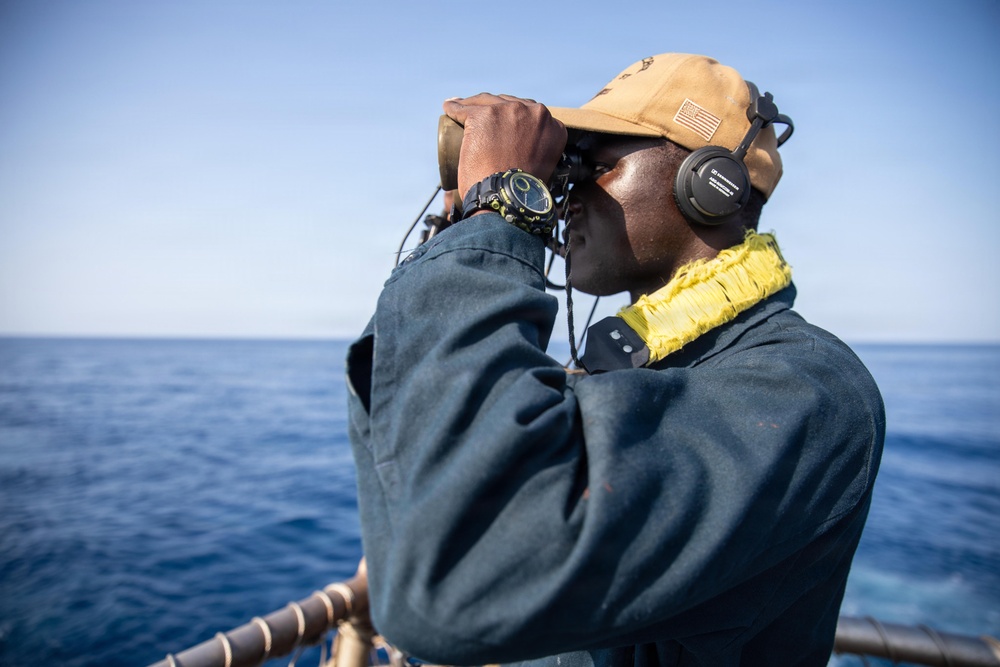 USS Mitscher (DDG 57) Sailor stands aft lookout watch on flight deck