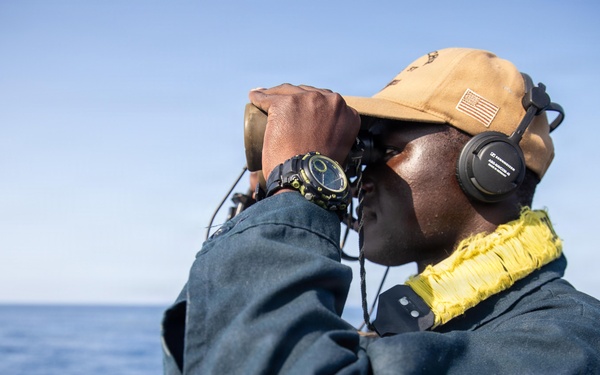 USS Mitscher (DDG 57) Sailor stands aft lookout watch on flight deck