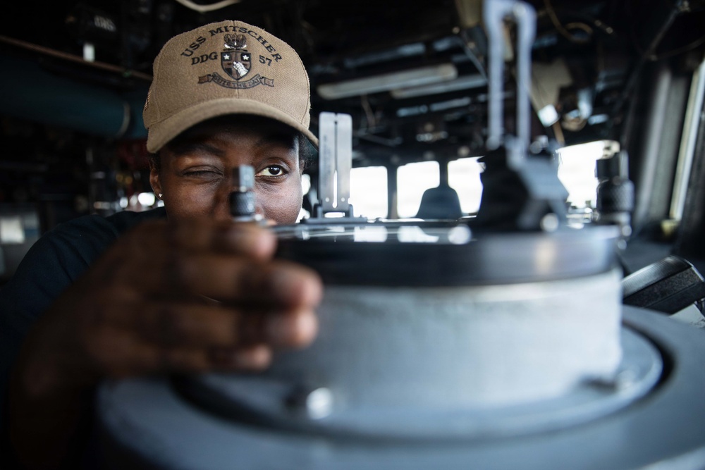 USS Mitscher (DDG 57) Sailor stands watch in ship bridge