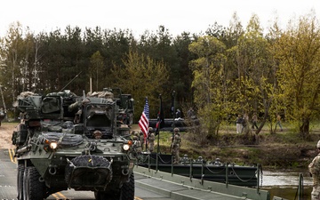 U.S. Soldiers traverse a wet gap crossing during Saber Strike