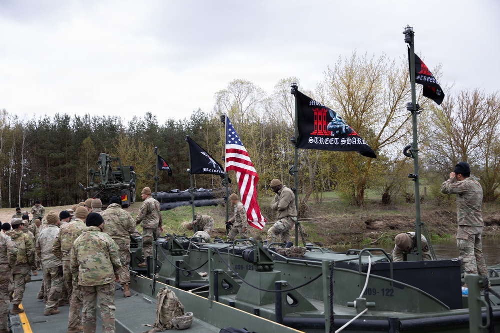 U.S. Soldiers from the 1st Squadron, 2d Cavalry Regiment, 809th Multi-Role Bridge Company, 15th Engineering Battalion, alongside Polish and Italian Armed Forces conduct a wet gap crossing