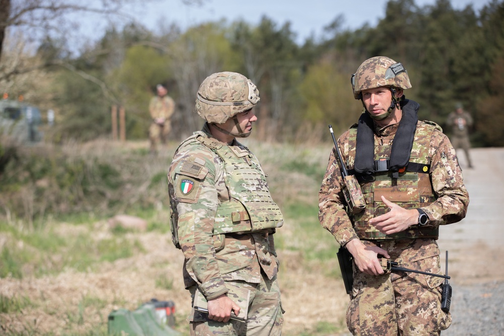 U.S. Soldiers from the 1st Squadron, 2d Cavalry Regiment and 809th Multi-Role Bridge Company, 15th Engineering Battalion conduct a wet gap crossing alongside Polish and Italian Armed Forces