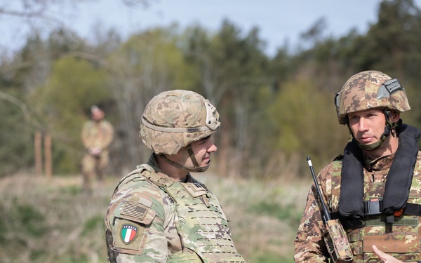 U.S. Soldiers from the 1st Squadron, 2d Cavalry Regiment and 809th Multi-Role Bridge Company, 15th Engineering Battalion conduct a wet gap crossing alongside Polish and Italian Armed Forces