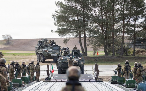 U.S. Soldiers from the 1st Squadron, 2d Cavalry Regiment, 809th Multi-Role Bridge Company, 15th Engineering Battalion, alongside Polish and Italian Armed Forces conduct a wet gap crossing
