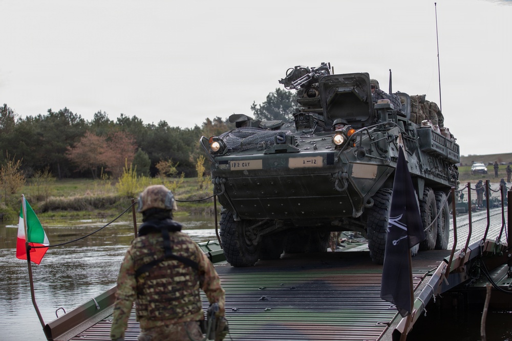 U.S. Soldiers from the 1st Squadron, 2d Cavalry Regiment, 809th Multi-Role Bridge Company, 15th Engineering Battalion, alongside Polish and Italian Armed Forces conduct a wet gap crossing