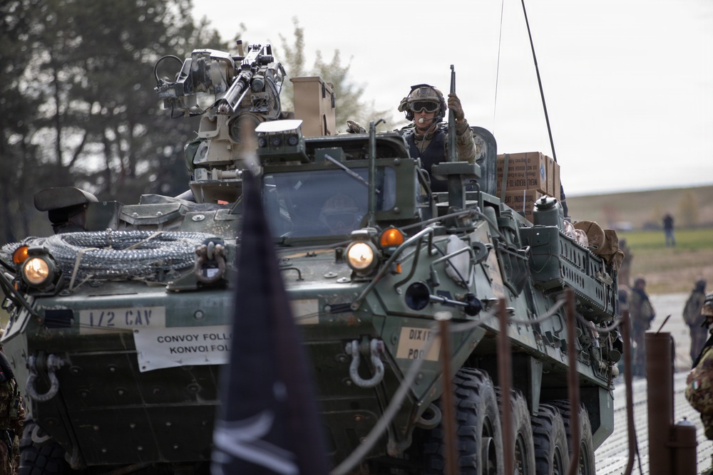U.S. Soldiers from the 1st Squadron, 2d Cavalry Regiment, 809th Multi-Role Bridge Company, 15th Engineering Battalion, alongside Polish and Italian Armed Forces conduct a wet gap crossing