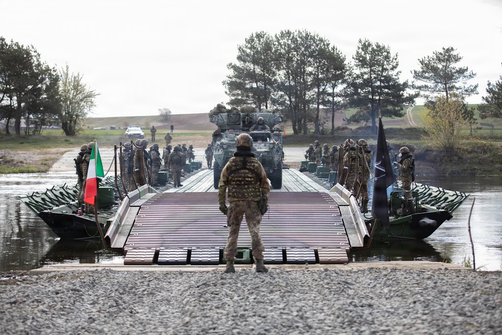 U.S. Soldiers from the 1st Squadron, 2d Cavalry Regiment, 809th Multi-Role Bridge Company, 15th Engineering Battalion, alongside Polish and Italian Armed Forces conduct a wet gap crossing