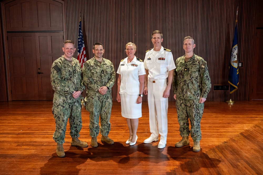 Navy Music promotes Commander Cartwright