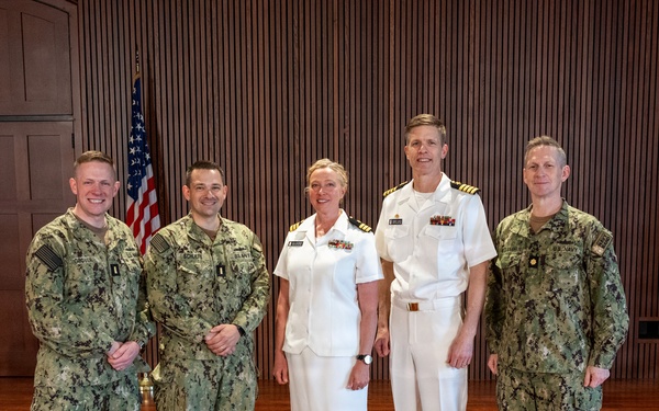 Navy Music promotes Commander Cartwright