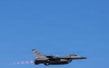 U.S. Marines and Sailors load ordnance on an F/A-18E Super Hornet