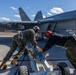 U.S. Marines and Sailors load ordnance on an F/A-18E Super Hornet