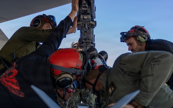 U.S. Marines and Sailors load ordnance on an F/A-18E Super Hornet