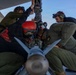U.S. Marines and Sailors load ordnance on an F/A-18E Super Hornet