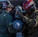 U.S. Marines and Sailors load ordnance onto an F/A-18E Super Hornet