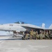 U.S. Marines and Sailors load ordnance on an F/A-18 Super Hornet