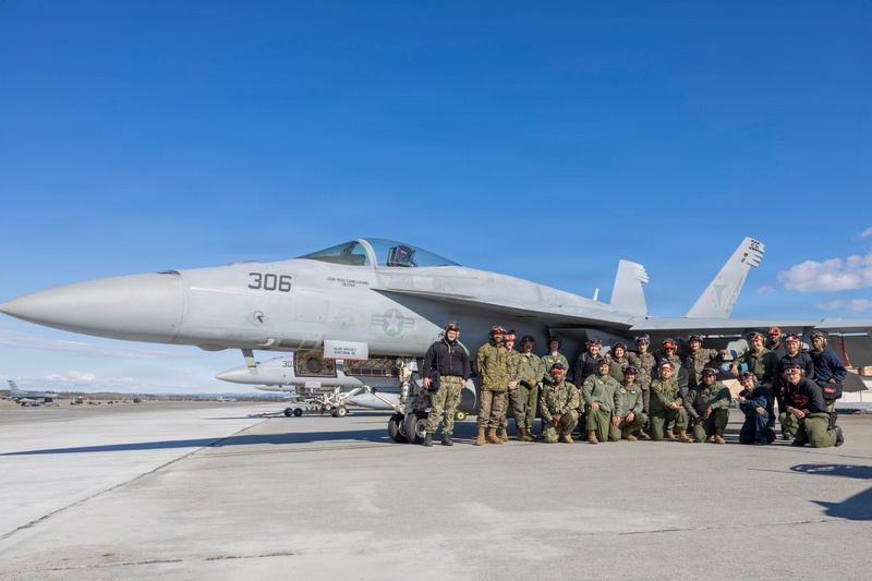 U.S. Marines and Sailors load ordnance on an F/A-18 Super Hornet