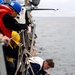 Sailor Detaches a Ladder During Small Boat Ops