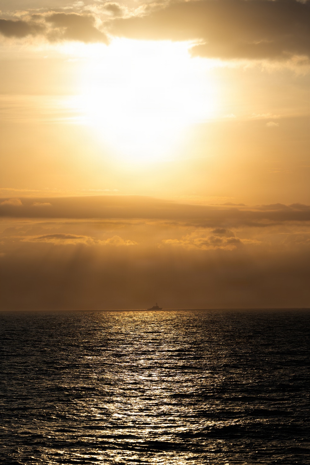 Destroyer Transits in Front of a Sunrise