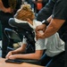 Massage therapist provides chair massage during military wellness event