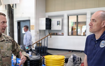 Army soldier and OEM representative discuss emergency preparedness at community outreach event