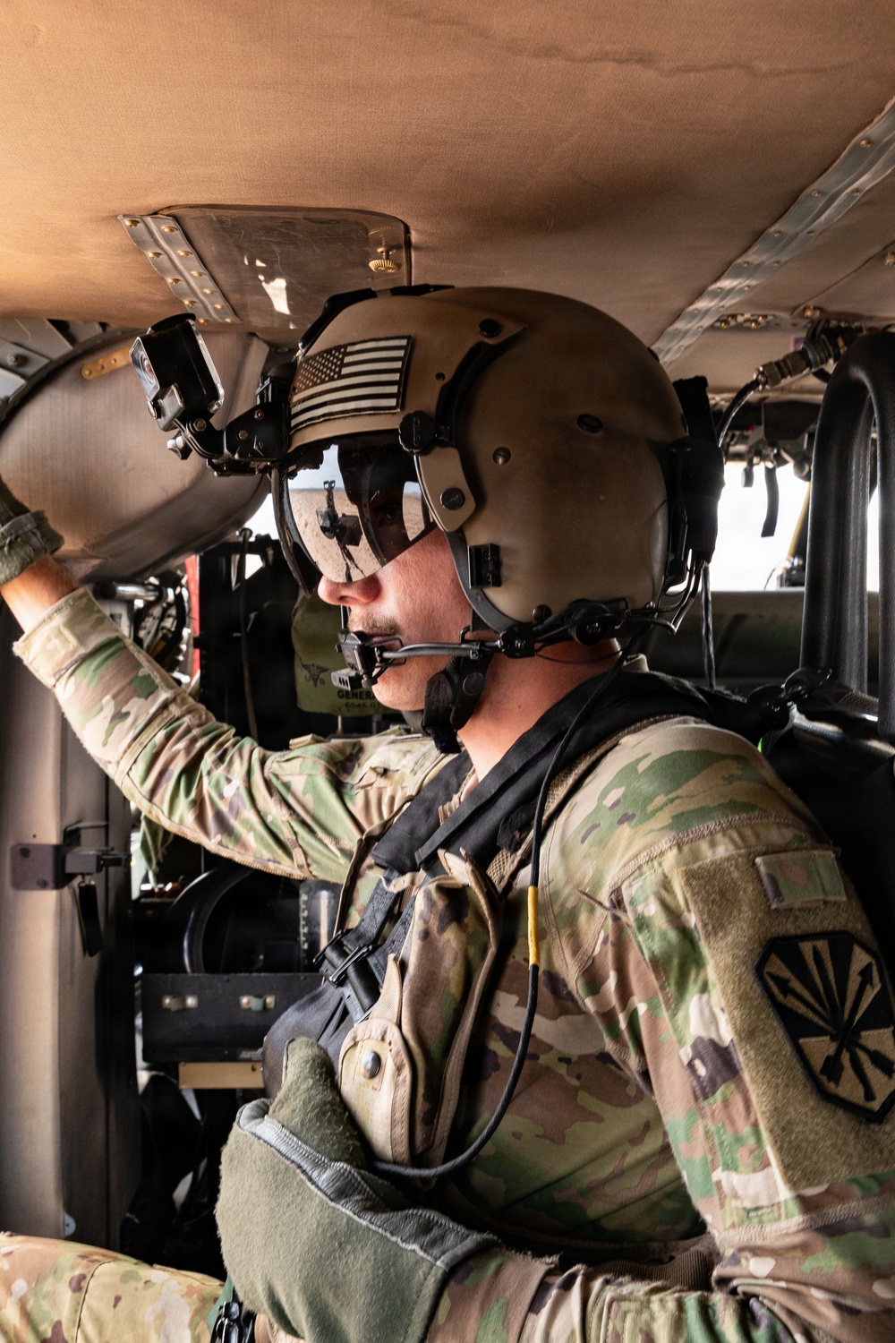 U.S. Army aviator conducts pre-flight checks aboard military helicopter