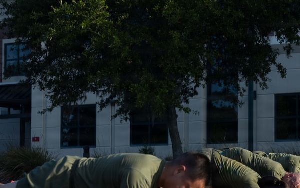 Marines attending 1st Sgts. Symposium Conduct physical training
