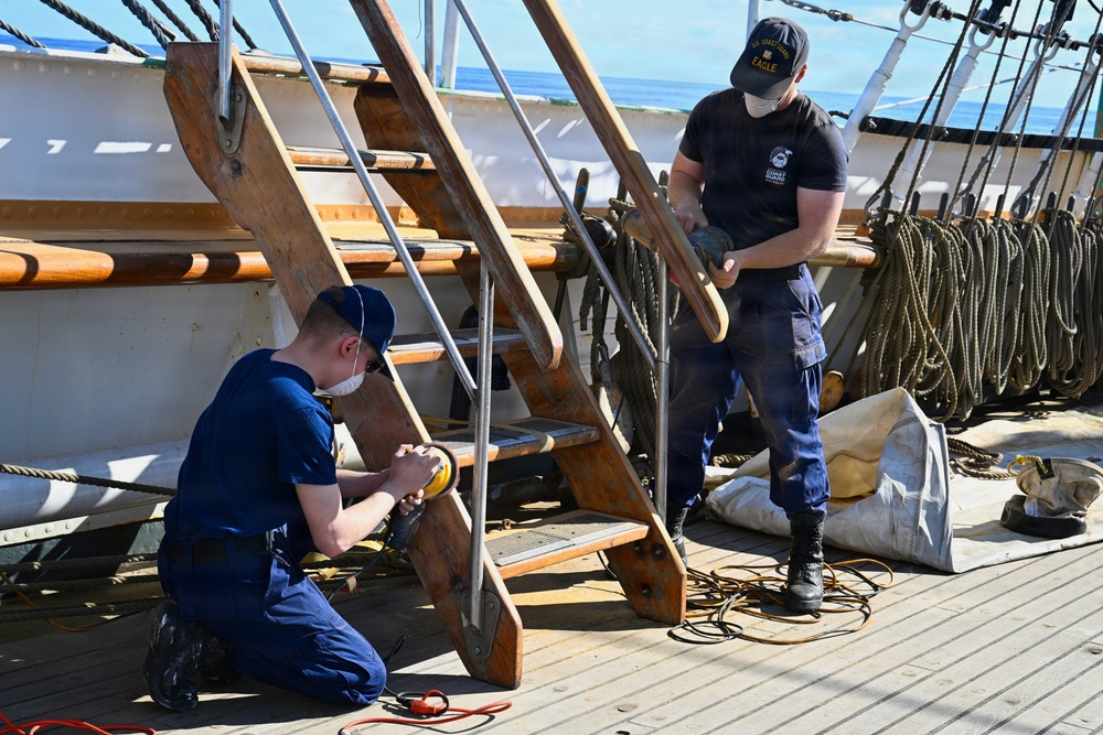 Coast Guard Cutter Eagle crew members conduct vessel upkeep
