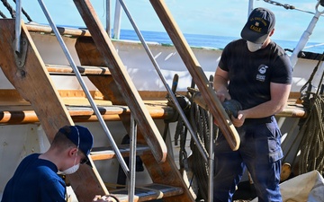 Coast Guard Cutter Eagle crew members conduct vessel upkeep