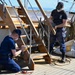 Coast Guard Cutter Eagle crew members conduct vessel upkeep