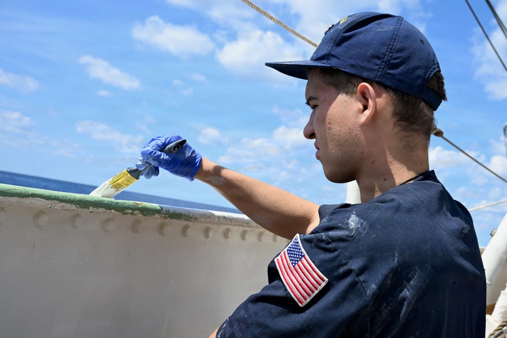 Coast Guard Cutter Eagle crew members conduct vessel upkeep