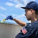 Coast Guard Cutter Eagle crew members conduct vessel upkeep