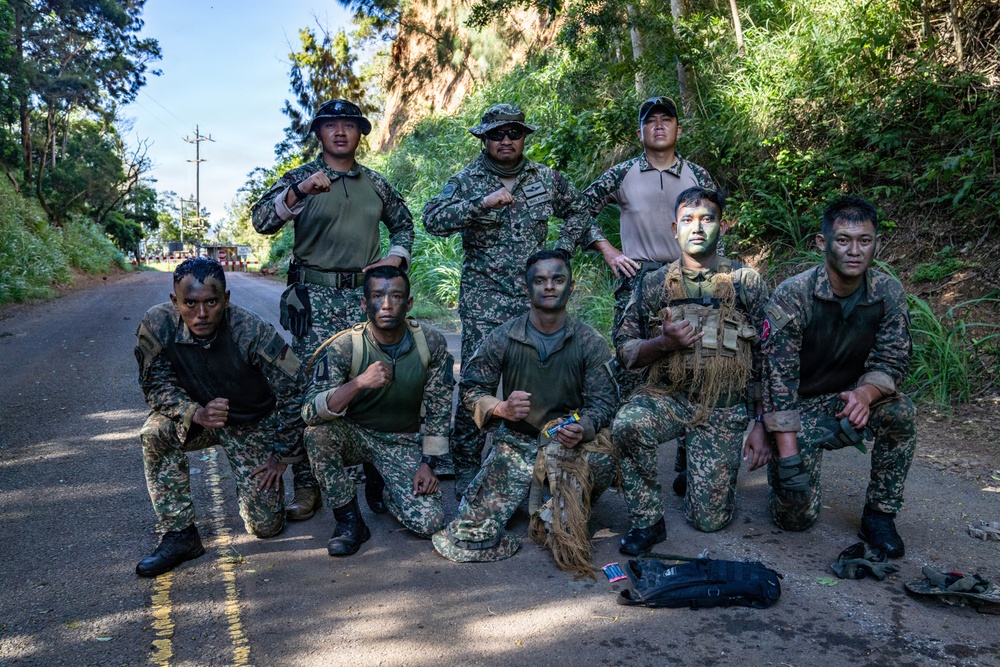 Multinational Soldiers hike Kolekole Pass at the 2026 Pacific Land Forces Team Readiness Challenge