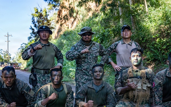 Multinational Soldiers hike Kolekole Pass at the 2026 Pacific Land Forces Team Readiness Challenge