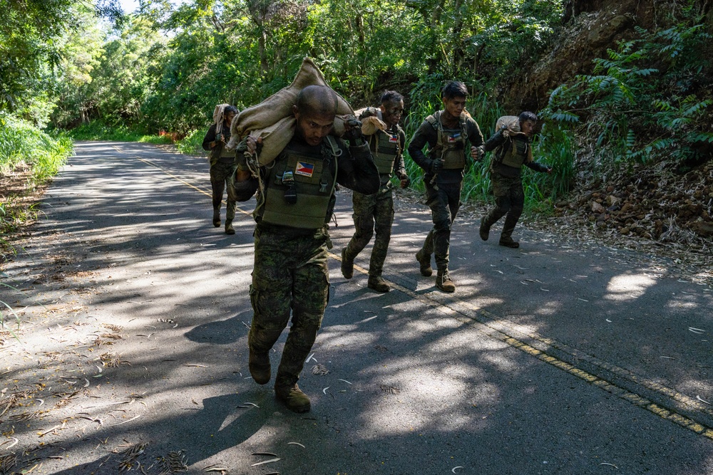 Multinational Soldiers hike Kolekole Pass at the 2026 Pacific Land Forces Team Readiness Challenge