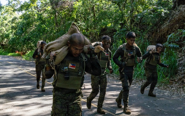 Multinational Soldiers hike Kolekole Pass at the 2026 Pacific Land Forces Team Readiness Challenge
