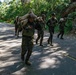 Multinational Soldiers hike Kolekole Pass at the 2026 Pacific Land Forces Team Readiness Challenge